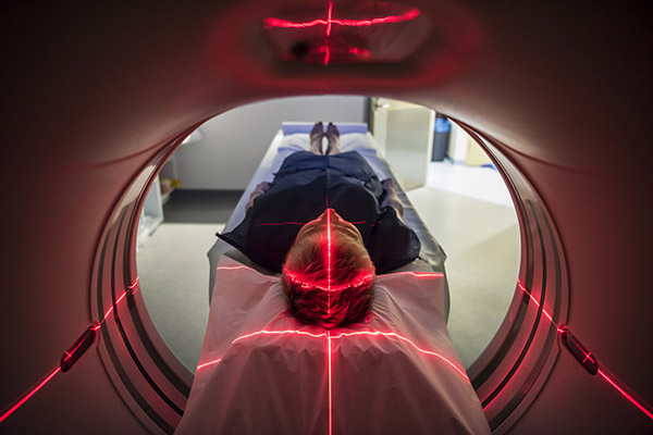 Person undergoing a CAT scan in hospital. PET scan equipment. Medical CT scan of patient.